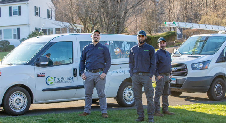 ProSource pest technicians standing in front of our service fleet outside a home being serviced in Southington
