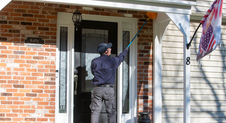 ProSource technician preparing the front porch of a customers home for treatment